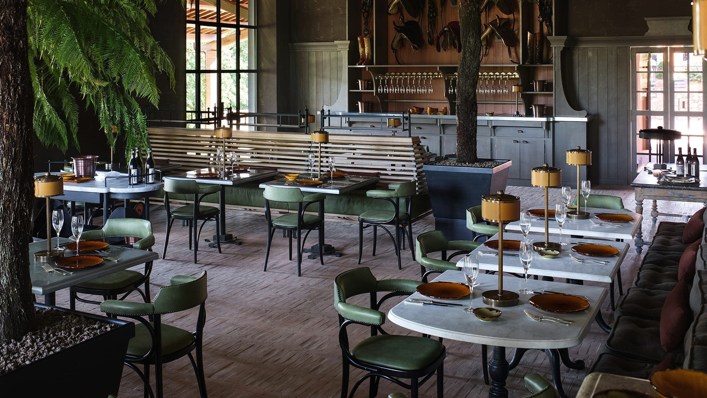 A long table set under the castello's portico, glassware and linen at the height of an Umbrian afternoon.